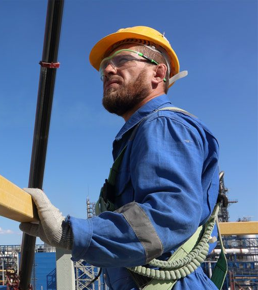 A tool used for completion and production silhouetted against a sunset